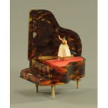 An early 20th century tortoiseshell miniature piano jewellery box, with musical movement. Width 9.