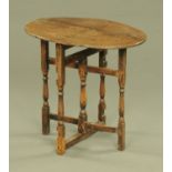An oak and mahogany folding gate leg table. top 68 cm x 49 cm.
