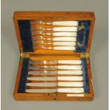 A case of six pairs of silver plated hors d'oeuvres knives and forks,