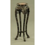 A Chinese hardwood rouge marble topped jardiniere stand, with pierced frieze and carved legs.