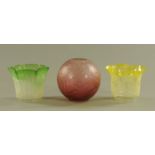 Three Victorian glass oil lamp shades, yellow, red and green.