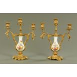 A pair of Continental porcelain and gilt metal mounted three branch candelabra, circa 1900,