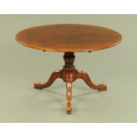 A reproduction George III style oak circular dining table,