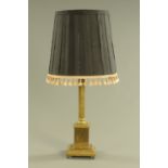 A brass table lamp, with fluted column and stepped base. Height including shade 84 cm.