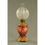 A 19th century brass and porcelain oil lamp, with etched and cut glass shade.
