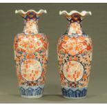 A pair of Japanese Imari baluster vases, decorated in typical Imari palette.