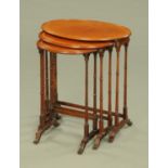 A nest of three Edwardian oval satinwood banded boxwood and ebony strung tables,