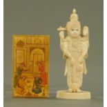 A carved Indian ivory deity, 19th century, together with a carved Indian ivory panel,