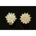 A pair of diamond cluster earrings on 9 ct gold mounts, each earring +/- 1/4 carat of diamonds.