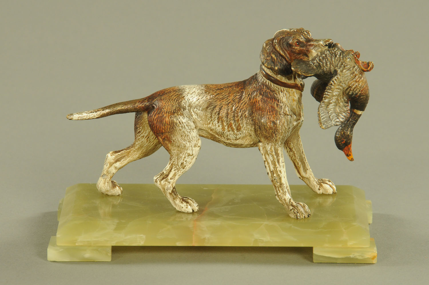 A German cold painted bronze of a gun dog with mallard, raised on an onyx base.