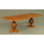 An oak refectory table, with bulbous cup and cover supports with cruciform bases beneath.