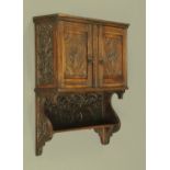 A late Victorian carved oak hanging cupboard and combined shelf unit. Width 64 cm, height 75 cm.