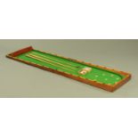 A Victorian table top bar billiards game, with cues and balls. Length closed 106 cm.