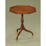 A George III style mahogany octagonal table, with wavy gallery,