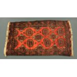 An Afghan red ground rug, 20th century,