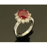 An 18 ct white gold ruby and diamond cluster ring, ruby weight +/- 3.03 carats, diamonds +/- 0.