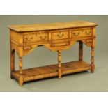 An Ipswich oak dresser base, with pegged top, moulded edge and series of frieze drawers,
