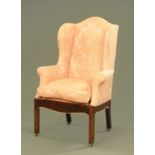 A George II/III oak wing armchair,