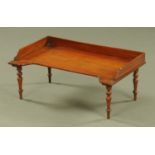 A William IV mahogany bed tray, raised on four short turned legs. 65 cm x 38.5 cm.