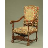 A large late 19th/early 20th century throne type armchair, with tapestry back and seat, carved arms,