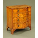 A 1930's walnut bow fronted chest of four drawers,