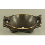 A large Dayak ironwood Chieftain's bowl, with mythical creature handles. Width 74 cm, height 35 cm.