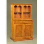 A 19th century oak glazed bookcase on cupboard, the drawer and cupboard fronts in burr oak.