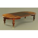 A large Victorian mahogany extending dining table, with wind out action and three leaves,