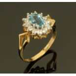 A 9 ct gold blue topaz and diamond cluster ring, yellow gold shank. Size N/O.