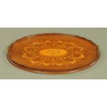 An Edwardian inlaid mahogany oval tray, with brass handles and wavy gallery. Length 66.