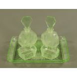 A pair of Art Deco green glass scent bottles, with matching tray and two pin dishes.