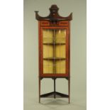 An Edwardian inlaid mahogany standing corner cupboard with rear upstand,