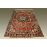 A very large Persian design carpet, in reds, blues and beige and with multiple line border.