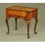 An 18th century walnut lowboy, with reentrant corners and single drawer with brass drop handles,