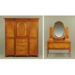 An Edwardian walnut bedroom suite, comprising wardrobe, pair of bed ends and dressing table,