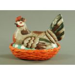 A 19th century Staffordshire hen on nest egg cruet, coloured bird, green and brown wings and tail,