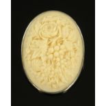A late 19th/early 20th century Cantonese carved ivory oval brooch, fruit and roses,