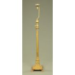 A Victorian brass Corinthian column lamp standard, with square stepped base raised on paw feet.