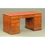 A Victorian mahogany pedestal desk, with red leatherette writing surface,