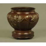 A Japanese signed bronze jardiniere raised on a wooden stand. Diameter +/- 20 cm.