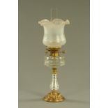 A late 19th century oil lamp, with etched glass shade,