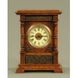 A late 19th century oak cased mantle clock, with two-train movement, alarm and musical comb.