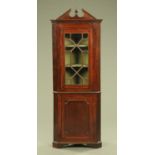 A 19th century mahogany standing corner cupboard in two sections,