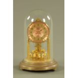 A brass anniversary clock, with pink dial and Arabic numerals under dome, overall height 22.5 cm.