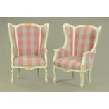 A pair of painted wooden wing armchairs, with gilt highlights,