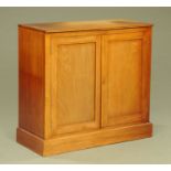 A Victorian mahogany cupboard, fitted with two doors and single shelf and raised on a plinth base.