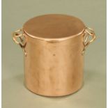 A large copper lidded pan,