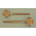 Two brass and copper warming pans, with turned wooden handles.