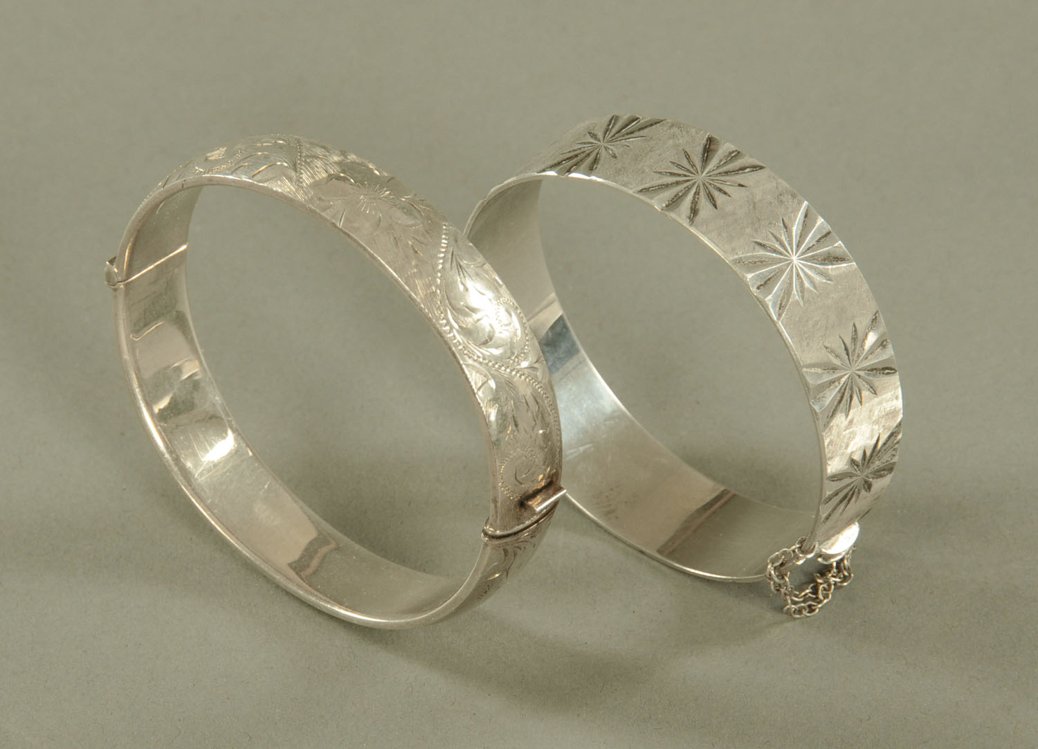 Two engraved silver bangles.