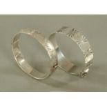 Two engraved silver bangles.
